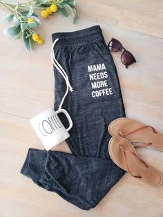 a woman's pants, coffee mug and sandals are on the floor