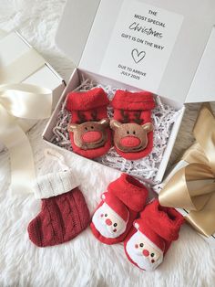 the baby's first christmas gift set includes red mittens, socks and booties