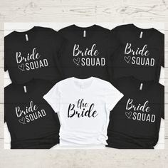 the bride squad shirts are on display in front of a white wooden background with black letters