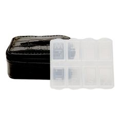 two empty plastic containers sitting on top of a black leather case next to each other