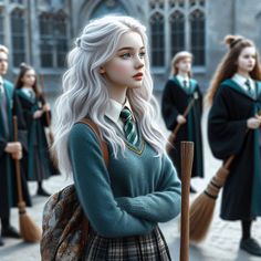 a group of young women standing next to each other in front of a hogwarts building