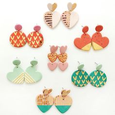 six pairs of heart shaped earring designs on white background with clippings attached to them