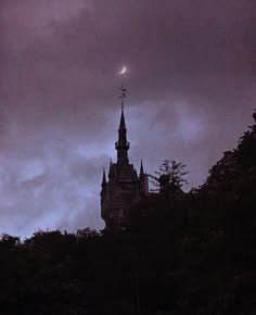 an old building with a clock on it's steeple under a cloudy sky