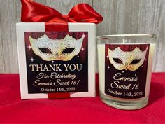 a candle with a red ribbon around it and a thank you sign next to it