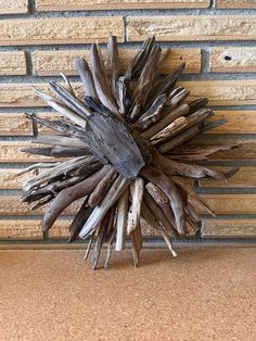 a piece of driftwood sitting on top of a counter next to a brick wall