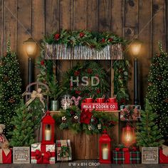 christmas decorations and presents are displayed on a wooden wall with lights, candles, and wreaths