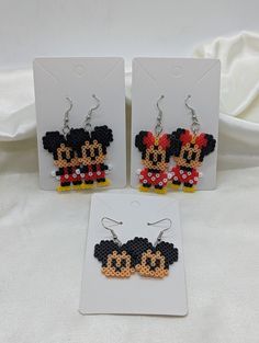 two pairs of mickey and minnie mouse beaded earrings with matching ear clips on white background