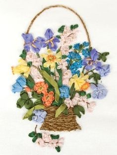 a basket filled with lots of colorful flowers