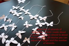 there are many butterflies on the table with words written in red and white letters above them