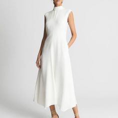 This Minimalist Maxi Is Designed With A High Neckline And Extended Shoulders. A Flowy A-Line Skirt Completes This Irresistible Look. 49" Length Mock Neck Extended Shoulders 94% Viscose, 6% Elastane Dry Clean High Neck White Satin Dress, Mock Neck Flowy Dress, Feminine White High Neck Dress, White Viscose Maxi Dress, White Non-stretch Maxi Dress, Fitted Knee Length Dress, White Stretch A-line Maxi Dress, Palm Print Dress, Long Sleeve Embroidered Dress