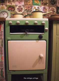 an old fashioned green stove in a kitchen