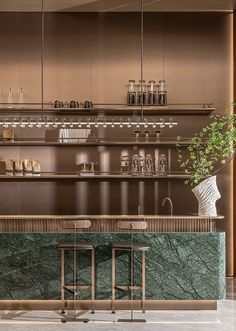 an elegant bar with marble counter tops and stools