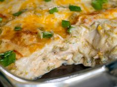 a casserole dish with cheese and green onions