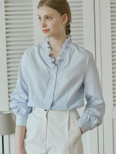 This is NONLOCAL’s frill-collar stripe blouse with smocked embroidery detail on the neckline, making it the focal point. Made of high-density cotton material, the texture of the stripe pattern adds a touch of luxury to the product. It can be styled in various looks, combining femininity with casualness.- Perfect for daily wear- Can be styled with different styles of bottoms for various looks- Can be fastened with buttons on the front Spring Office Blouse With Striped Collar, Elegant Blouse With Striped Collar For Daywear, Spring Office Tops With Striped Collar, Elegant Spring Tops With Striped Collar, Elegant Striped Cotton Blouse, Cotton Blouse With Striped Collar For Office, Spring Daywear Blouse With Striped Collar, Cotton Tops With Ruffled Collar For Office, Cotton Top With Ruffled Collar For Office