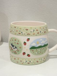 a ceramic mug with farm animals on it