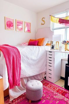 a bedroom with pink and orange decor on the walls