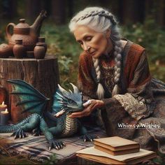 an older woman sitting next to a blue dragon figurine on top of a table