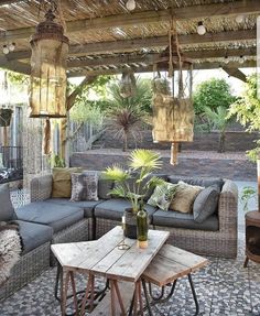 an outdoor living area with couches and tables