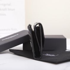 an open black case sitting on top of a table next to a pair of scissors