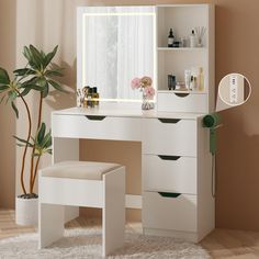 a white desk with drawers and a mirror on it next to a potted plant