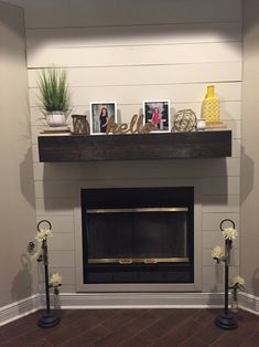 the fireplace is decorated with flowers and pictures