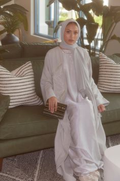 Introducing our first ever Linen Abaya, perfect for that bit of extra comfort! Delicately adorned with leaves outlined in beadwork, with folded cuffs for an elegant finish. The texture and flow of the fabric provide the highest level of comfort, with an oversized, relaxed and modest fit. Includes plain slip and matching hijab (clothing shown in images were styled for shoot purposes only). The model is 5.9 and wears a size 60. Elegant Hijabi Outfits, Linen Abaya, Embroidered Abaya, Slip Wedding Dress, Modest Wardrobe, Dusty Sage, Modest Fits, Hijabi Aesthetic, Hijabi Outfits Casual