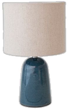 a blue table lamp with a white shade on it's base and a beige linen lampshade