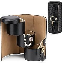 two black jewelry cases with pearls and chains on them, one is open to show the contents