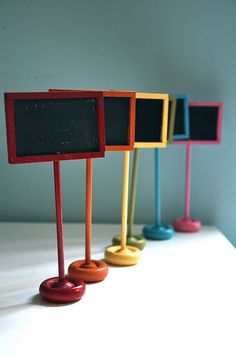 four different colored chalkboards are lined up in a row