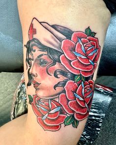 a woman's leg with roses on it and a nurse hat over her head