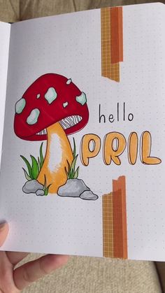 a hand holding an open notebook with the words hello poril on it and a mushroom