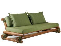 a wooden couch with green pillows on it