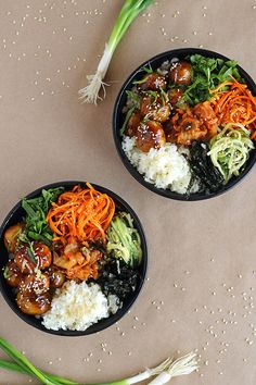 two black bowls filled with different types of food