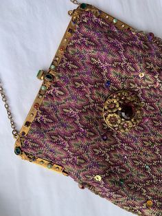 Beautiful jewelled gilt purse frame with fillagree details . All the jewels are present. It measures 6 inches wide . No markings are present but I feel it is Austrian made around 1940 . I have remade the purse in woven silk that was once part of an antique shawl . These shawls date from the 1920s  . The colours are incredible and an antique dealer told me that when they had finished manufacturing these shawls they sold the looms to the Missoni family . This fabric is even finer and changes colou Lingot D'or, Purse Frame, Gold Bullion, Vintage Ribbon, The 1920s, Hand Beading, Clutch Handbag, Missoni, Crochet Flowers