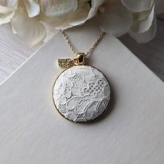 This vintage lace necklace is the perfect gift for those that love a timeless and elegant style. The white floral lace from the 1950s evokes a sense of delicate beauty, with a background of shiny cream color satin that highlights the intricate lace design. It's set in a gold metallic metal alloy pendant, with a dainty gold stainless steel chain that measures 22 inches in total length. Letter charm: The finishing touch is the capital letter initial charm that adorns the top of the pendant. This charm offers the perfect way to make this necklace a thoughtful and personalized gift. Gift box: The necklace will be packaged in a stylish, branded gift box, ready to be presented with love and care.  Gift notes:  Write a personalized note to your loved one at checkout, and it will be printed on dec 13th Anniversary Gifts, 13th Anniversary, Anniversary Gift For Wife, Lace Necklace, Delicate Beauty, Letter Charm, Anniversary Gifts For Wife, Personalized Gifts For Her, Branded Gifts