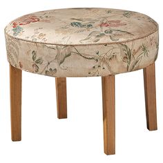 an upholstered stool with wooden legs and floral fabric on the backrests