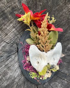 an elephant head with flowers on top of it