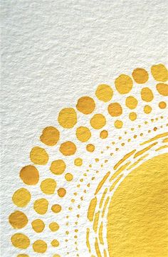 a close up of a yellow and white paper with circles on it, as well as an orange cat