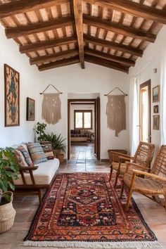 a living room filled with lots of furniture next to a rug on top of a floor