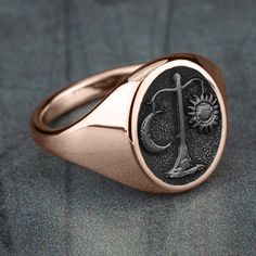 Libra - The Scales: You are known for your good taste, elegance, and charm. Peace and tranquility are important to you. Your personality brings a fair balance and different perspective to those around you, making others feel comfortable in your presence. 16mm oval signet ring 10K Rose Gold with Tantalum Grey center Available in 2 fits: Luxe and Basic Available in 2 finishes: Satin and Polish Luxury Signet Ring With Shiny Finish For Formal Occasions, Luxury Shiny Finish Signet Ring For Formal Occasions, Elegant Rose Gold Signet Ring With Polished Finish, Luxury 14k Rose Gold Oval Jewelry, Luxury Oval Signet Ring With Polished Finish, Timeless Polished Rose Gold Signet Ring, Timeless Rose Gold Signet Ring With Polished Finish, Timeless Rose Gold Signet Ring, Timeless Oval Jewelry With Shiny Finish