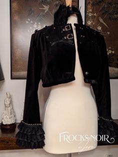 A 'Swifties' style winter velvet jacket. The collar is made with black iridescent millinery feathers. The front panels are faux leather with studs and silver buckles for closure. There are epaulets with silver insignia buttons. The sleeves are trimmed silver studs to which a triple layer of gathered lace hems the sleeve cuffs. Completely lined with a black silky polyester, the jacket hem is  a black velvet ribbon. A versatile addition to your wardrobe and ready to be your signature accessory for your winter 'Swifties' concert . size: M    bust: 36"-38" Fitted Steampunk Party Outerwear, Black Velvet Costume Outerwear, Gothic Rivets Outerwear For Cosplay, Gothic Studded Winter Outerwear, Gothic Riveted Outerwear For Cosplay, Cosplay Feathers, Gothic Outerwear With Rivets, Gothic Black Leather Jacket With Studs, Fitted Gothic Velvet Outerwear