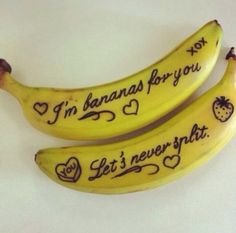 two bananas with writing on them sitting next to each other in front of a white background