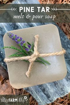 a soap bar with lavender flowers tied to it and the words pine tar melt & pour soap