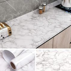 a kitchen counter with white marble on it and gold accents in the middle, next to a toaster oven