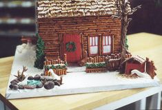 a gingerbread house on a table with decorations