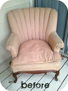 a pink chair sitting on top of a wooden floor next to a door and window