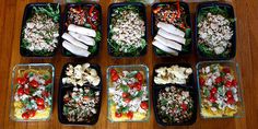 six plastic containers filled with food on top of a wooden table