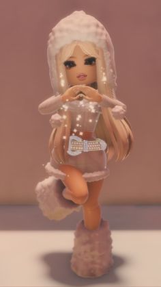 a doll with blonde hair wearing a white dress