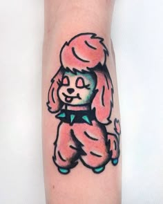 a cartoon dog tattoo on the arm