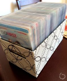 a stack of files sitting on top of a wooden table